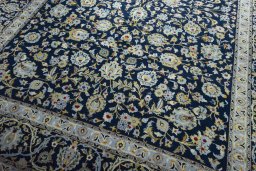 Close-up detail of 2000s Kashan rug from Iran / Persia showing Wool weave