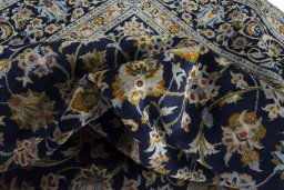 Surface texture of 2000s Kashan rug with natural Wool and intricate pattern