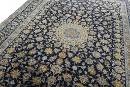 Backside of handmade 2000s Kashan rug showing knot structure and weave density