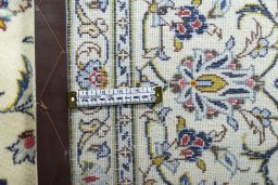 Backside of handmade 2000s Kashan rug showing knot structure and weave density