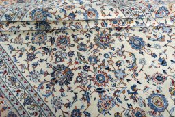 Backside of handmade 2000s Kashan rug showing knot structure and weave density