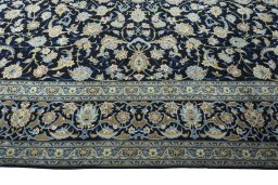 Corner detail of 2000s Kashan rug showing border pattern and Wool pile