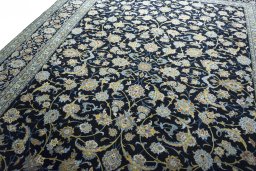 Backside of handmade 2000s Kashan rug showing knot structure and weave density