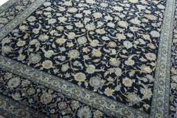 Close-up detail of 2000s Kashan rug from Iran / Persia showing Wool weave