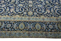 Corner detail of 2000s Kashan rug showing border pattern and Wool pile