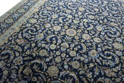 Backside of handmade 2000s Kashan rug showing knot structure and weave density