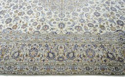 Corner detail of 2000s Kashan rug showing border pattern and Wool pile
