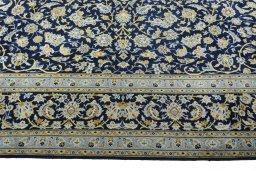 Corner detail of 2000s Kashan rug showing border pattern and Wool pile