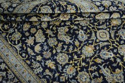 Close-up detail of 2000s Kashan rug from Iran / Persia showing Wool weave