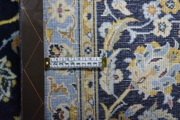 Backside of handmade 2000s Kashan rug showing knot structure and weave density