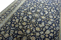 Backside of handmade 2000s Kashan rug showing knot structure and weave density
