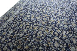 Backside of handmade 2000s Kashan rug showing knot structure and weave density