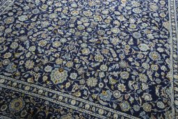 Close-up detail of 2000s Kashan rug from Iran / Persia showing Wool weave