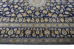 Corner detail of 2000s Kashan rug showing border pattern and Wool pile
