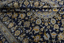 Backside of handmade 2000s Kashan rug showing knot structure and weave density