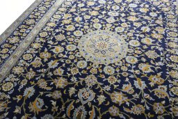 Backside of handmade 2000s Kashan rug showing knot structure and weave density