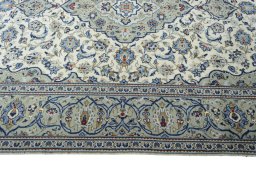 Corner detail of 2000s Kashan rug showing border pattern and Wool pile