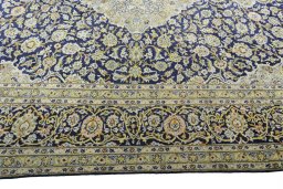 Corner detail of 2000s Kashan rug showing border pattern and Wool pile