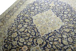 Backside of handmade 2000s Kashan rug showing knot structure and weave density