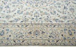 Corner detail of 2000s Kashan rug showing border pattern and Wool pile