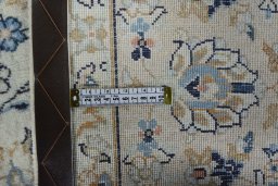 Backside of handmade 2000s Kashan rug showing knot structure and weave density