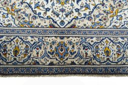 Corner detail of 2000s Kashan rug showing border pattern and Wool pile