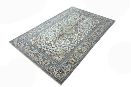 Corner detail of 2000s Kashan rug showing border pattern and Wool pile