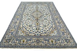 Backside of handmade 2000s Kashan rug showing knot structure and weave density