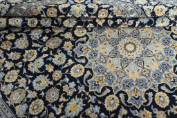 Close-up detail of 2000s Kashan rug from Iran / Persia showing Wool weave