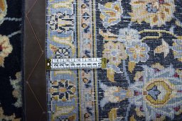 Backside of handmade 2000s Kashan rug showing knot structure and weave density