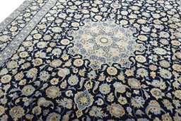 Backside of handmade 2000s Kashan rug showing knot structure and weave density