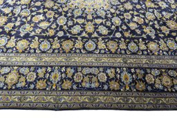 Corner detail of 2000s Kashan rug showing border pattern and Wool pile