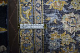 Backside of handmade 2000s Kashan rug showing knot structure and weave density