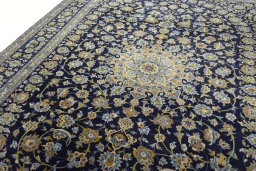 Backside of handmade 2000s Kashan rug showing knot structure and weave density
