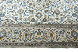 Corner detail of 2000s Kashan rug showing border pattern and Wool pile