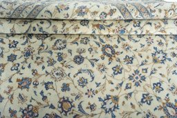 Corner detail of 2000s Kashan rug showing border pattern and Wool pile