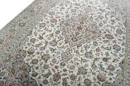 Backside of handmade 2000s Kashan rug showing knot structure and weave density