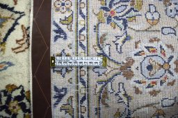 Backside of handmade 2000s Kashan rug showing knot structure and weave density