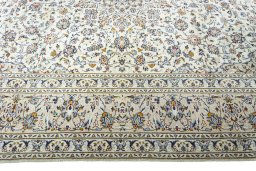 Corner detail of 2000s Kashan rug showing border pattern and Wool pile