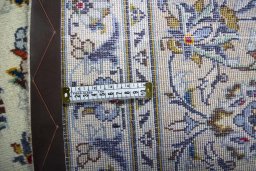 Backside of handmade 2000s Kashan rug showing knot structure and weave density
