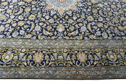 Corner detail of 2000s Kashan rug showing border pattern and Wool pile