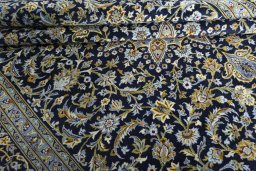 Close-up detail of 2000s Kashan rug from Iran / Persia showing Wool weave