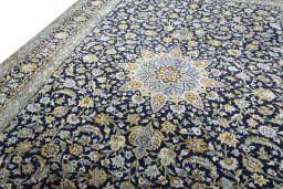 Backside of handmade 2000s Kashan rug showing knot structure and weave density