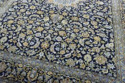 Close-up detail of 2000s Kashan rug from Iran / Persia showing Wool weave