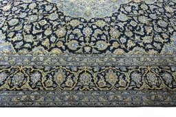 Corner detail of 2000s Kashan rug showing border pattern and Wool pile