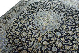 Backside of handmade 2000s Kashan rug showing knot structure and weave density