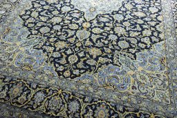 Close-up detail of 2000s Kashan rug from Iran / Persia showing Wool weave