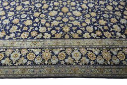 Corner detail of 2000s Kashan rug showing border pattern and Wool pile