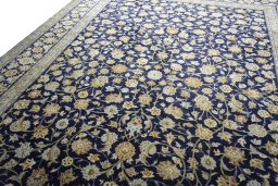 Backside of handmade 2000s Kashan rug showing knot structure and weave density