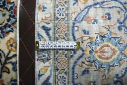 Backside of handmade 2000s Kashan rug showing knot structure and weave density
